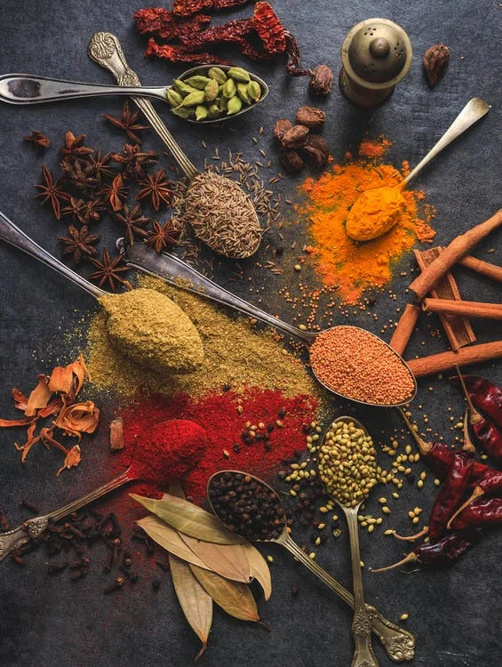 Assorted colourful spices and herbs used in Classique Catering Creations dishes